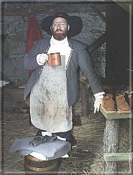 The cobbler takes a break and a swig of ale.