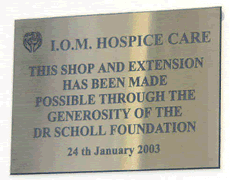 A brass plaque in the Castletown shop recording that the Scholl Foundation has funded the shaop alterations